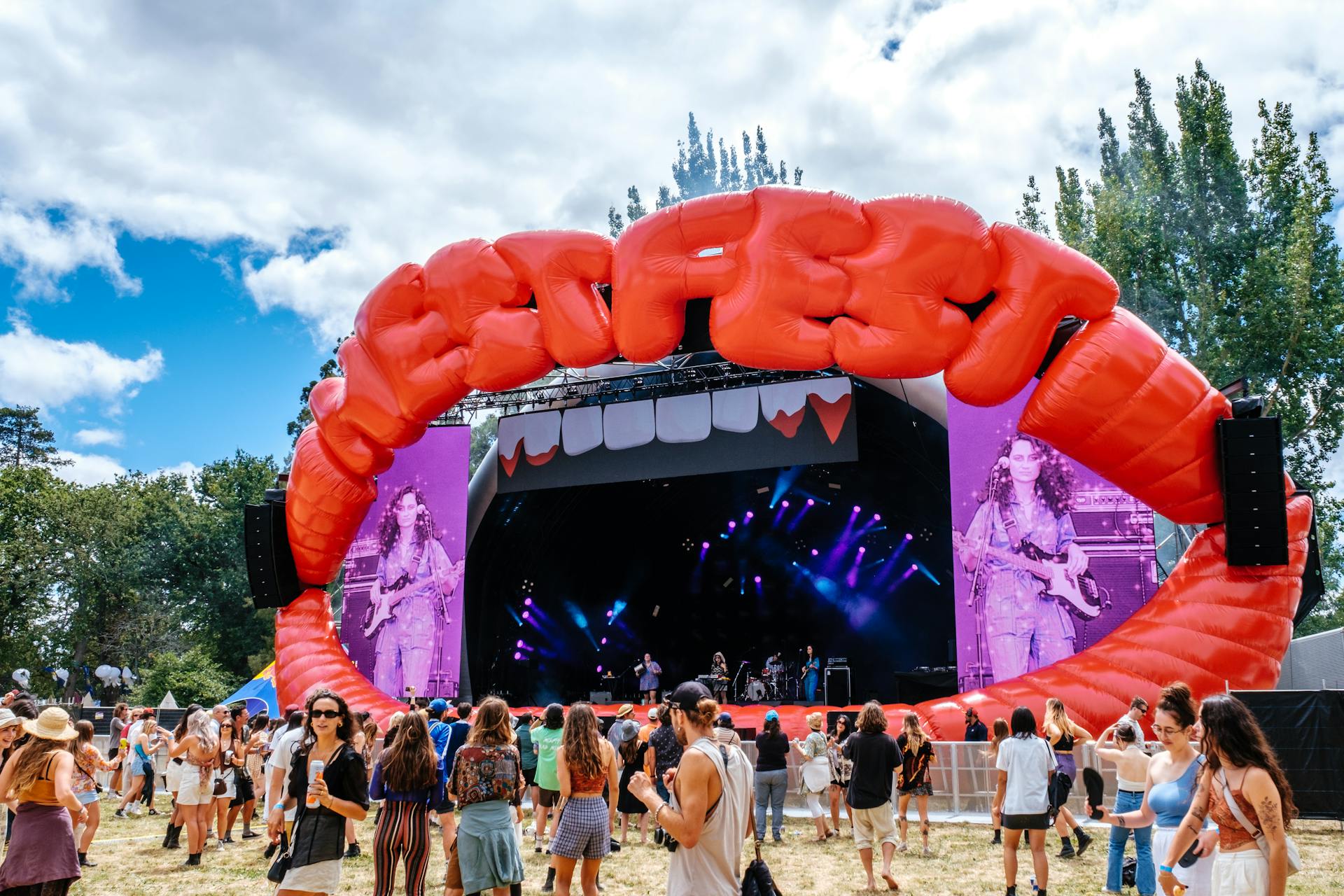Large sculptural Nest Fest stage structure at a public festival